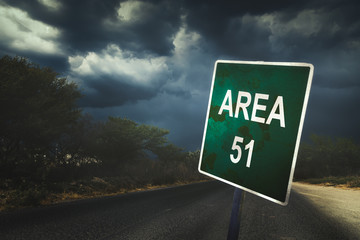 Area 51 sign on a road with dramatic lighting