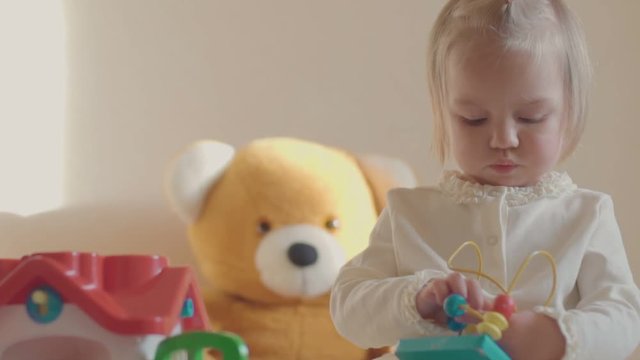 little girl in a room with toys