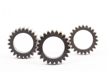 Small group of gears with their teeth engaged on a white background.