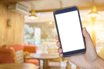 Man hand holding mobile smart phone , tablet,cellphone over Blur or Defocus image of Coffee Shop or Cafeteria,Customer at restaurant blur background with bokeh ,vintage color,food online call shopping