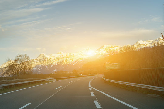 Beautiful landscape, road and green and yellow meadow with field and snow mountain and village,vintage color,selective focus
