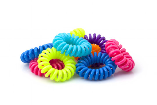 Multicolored rubber bands for hair from a telephone cord on a white background