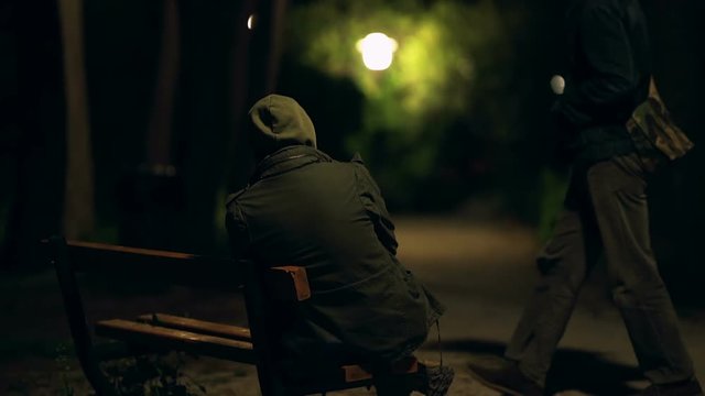 Two hooded men doing transaction at night,suspicious activity