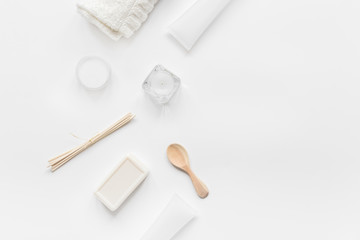 white cosmetic set on desk background top view mock up