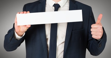 Business man torso with blank card ahd thumbs up against grey background
