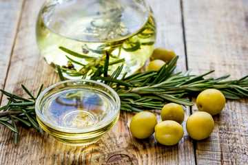 olive oil with ingredients on kitchen table background
