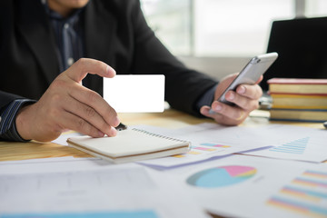 man verifies account balance on smartphone with mobile banking application.Online payment,Businessmen's hands holding a credit card and using smart phone for online shopping 