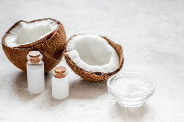 fresh coconut with cosmetic oil in jar on white background