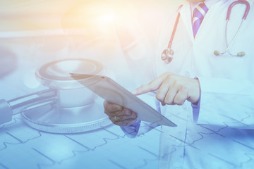 Doctor use tablets computer,Medical Diagnosis And prepare for surgery,doctor recording in Digital clipboard for diagnosis disease,Health Check with digital system support for patient,selective focus