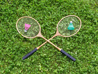 Badminton rackets and shuttlecocks on grass