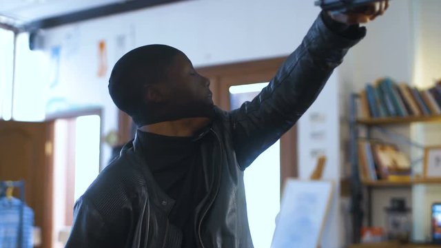 Two bandits with guns and in leather jackets come into cafe and take away money from cash desk