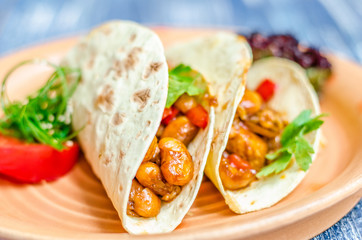 Stewed beans with herbs in the dough, tomato and green algae