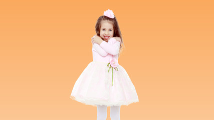 Elegant little girl in a pink dress.