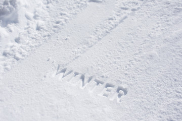 Winter text debossed in snow