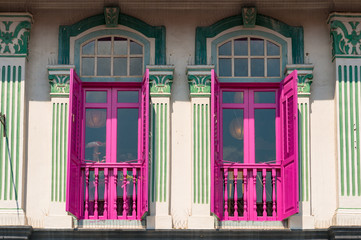 Brightly painted windows on victorian style facade