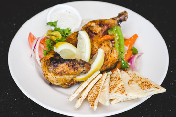 Pita bread, rice, grilled chicken and veggies on the plate