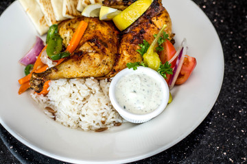 Pita bread, rice, grilled chicken and veggies on the plate