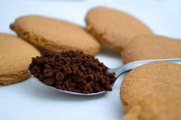 Heart shape made of gingerbread and teaspoon with black coffee