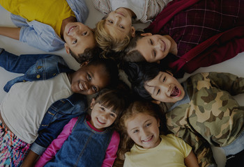 Group of Kids Laying on the Floor Smiling Cheerful Happiness Face