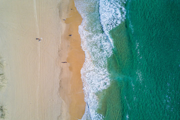 Aerial view of splashing sea waves and beach at Gold Coast.