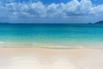 Tropical island beach with white sand and crystal clear water