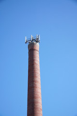 communication antenna installed on top of the brick chimney