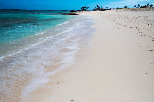 A beautiful view of the beach with a crystal clear water from the ocean. New Providence, Nassau, Bahamas.