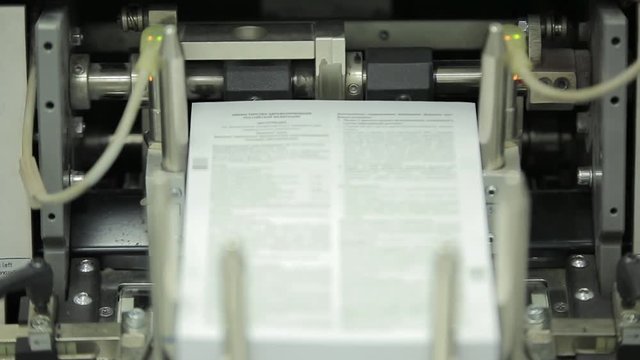 Machine working in printing house, polygraph industry - cleaning equipment, front view. Special equipment for sorting pages. Print shop press printing - Finishing line. Post press finishing line