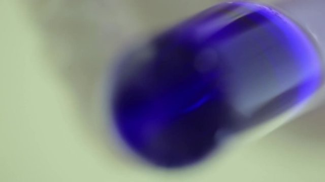 Test tubes closeup. Medical equipment. Close-up footage of a scientist using a micro pipette in a laboratory. Laboratory technician injecting liquid into a microtiter plate. Test tubes. Small depth of