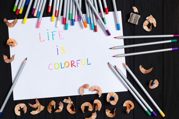 Sheet of paper with life is colorful text color pencils set