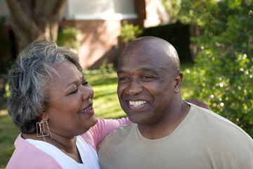 Obraz premium Mature African American couple laughing and hugging.