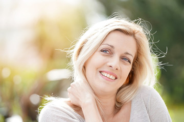 Portrait of attractive blond woman standing outside