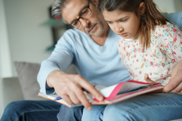 Man helping daughter with homework