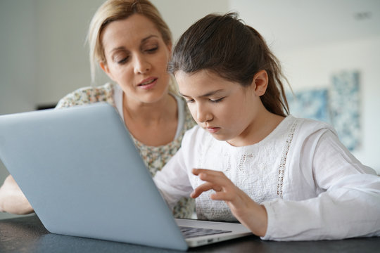 Woman watching her daughter while connected on internet