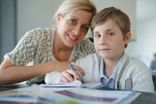 Woman helping son with homework