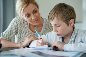 Woman helping son with homework