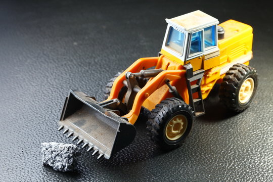 Old and dirty bulldozer die cast toy model represent the construction toy model concept related idea.
