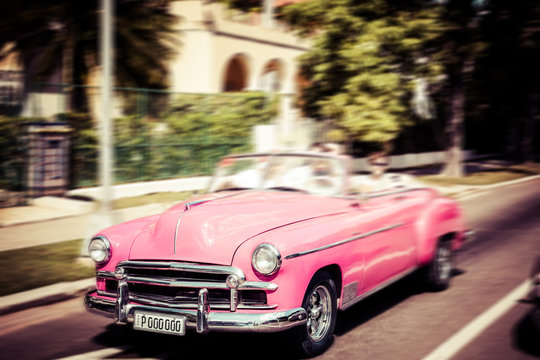 Tourists riding in oldtimer car in Havana. Concept of Cuba attractions.