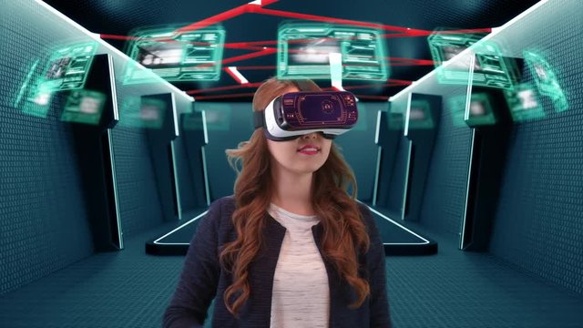 Young Asian female wearing virtual reality goggles uses futuristic holographic interface to access digital data