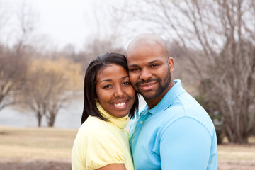 Obraz premium Loving happy African American couple hugging and smiling.