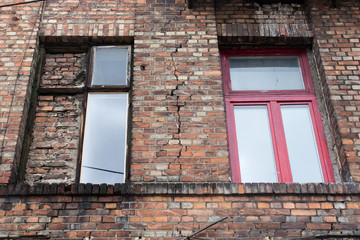 The facade of the old abandoned house with windows