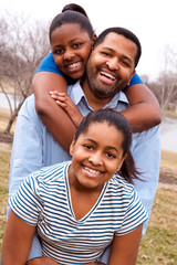 African American father and his young daughters.