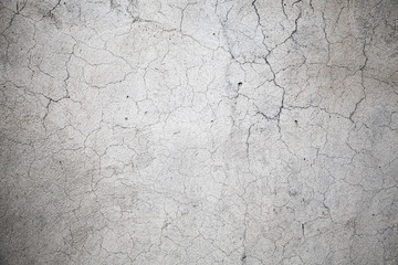 Gray concrete wall with cracks pattern