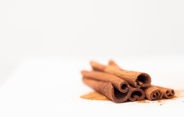 Cinnamon sticks on white background, place for text