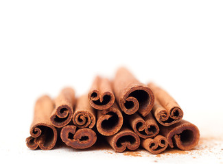 Cinnamon sticks on white background, place for text