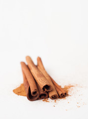 Cinnamon sticks on white background, place for text