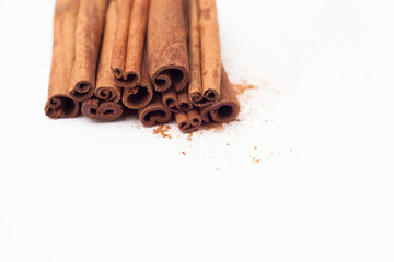 Cinnamon sticks on white background, place for text