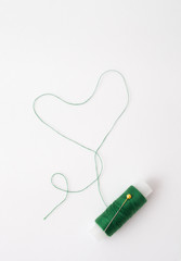 Colored thread coils on white background, sewing tools