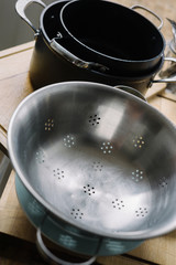 Kitchenware drying on table in sunny kitchen room.