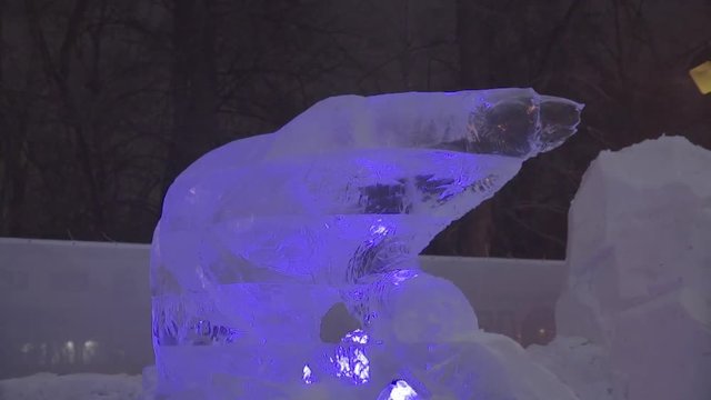 Icy sculpture of frozen polar bear in winter city. Ice Sculptures in Russia. Sculptures In The Ice town. Ice Sculpture and Beautiful Snows Falls
